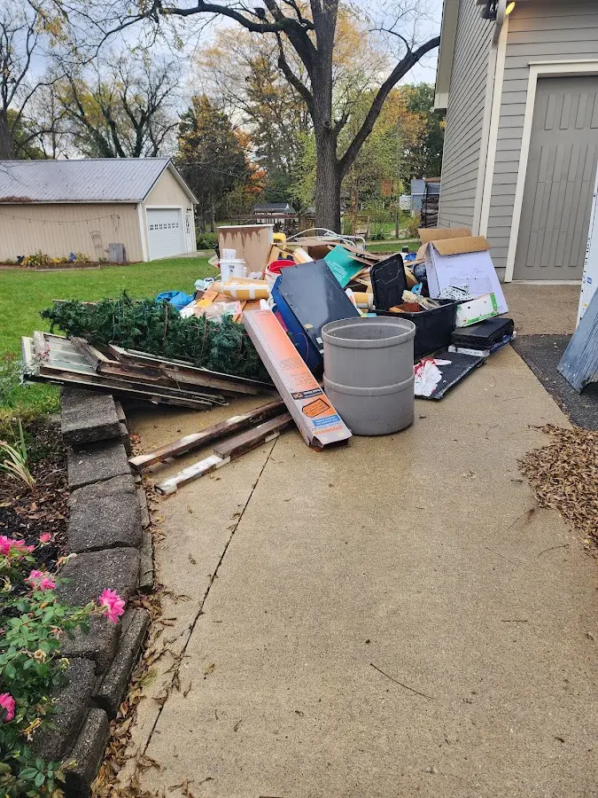 Dumpster being loaded with debris for Estate Cleanout Dumpster Rental in Spring Lake Park
